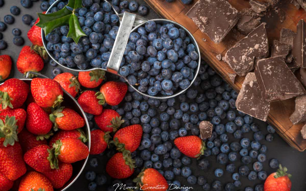 HD PC desktop wallpaper still life of ripe strawberries and scattered blueberries with broken dark chocolate pieces — vivid berry fruit close-up