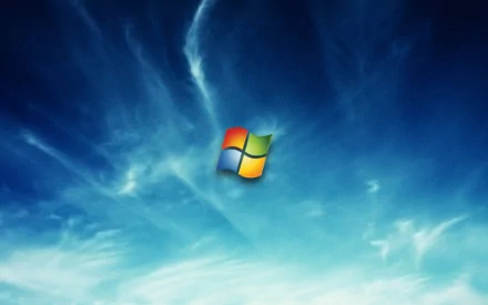 A vibrant HD desktop wallpaper featuring the Windows logo, set against a blue sky with wispy clouds, reflecting Microsoft's technology aesthetic.