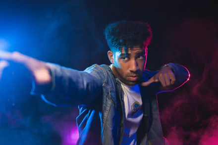 HD desktop wallpaper featuring a person named Kyle in a dynamic pose with a vivid, colorful smoke background.