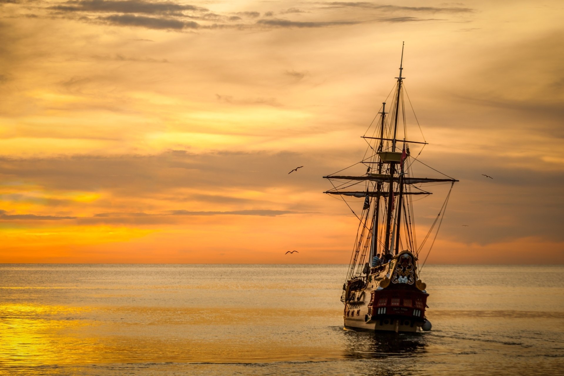 Sailboat Silhouetted at Golden Sunset Over Calm Ocean Horizon – HD ...