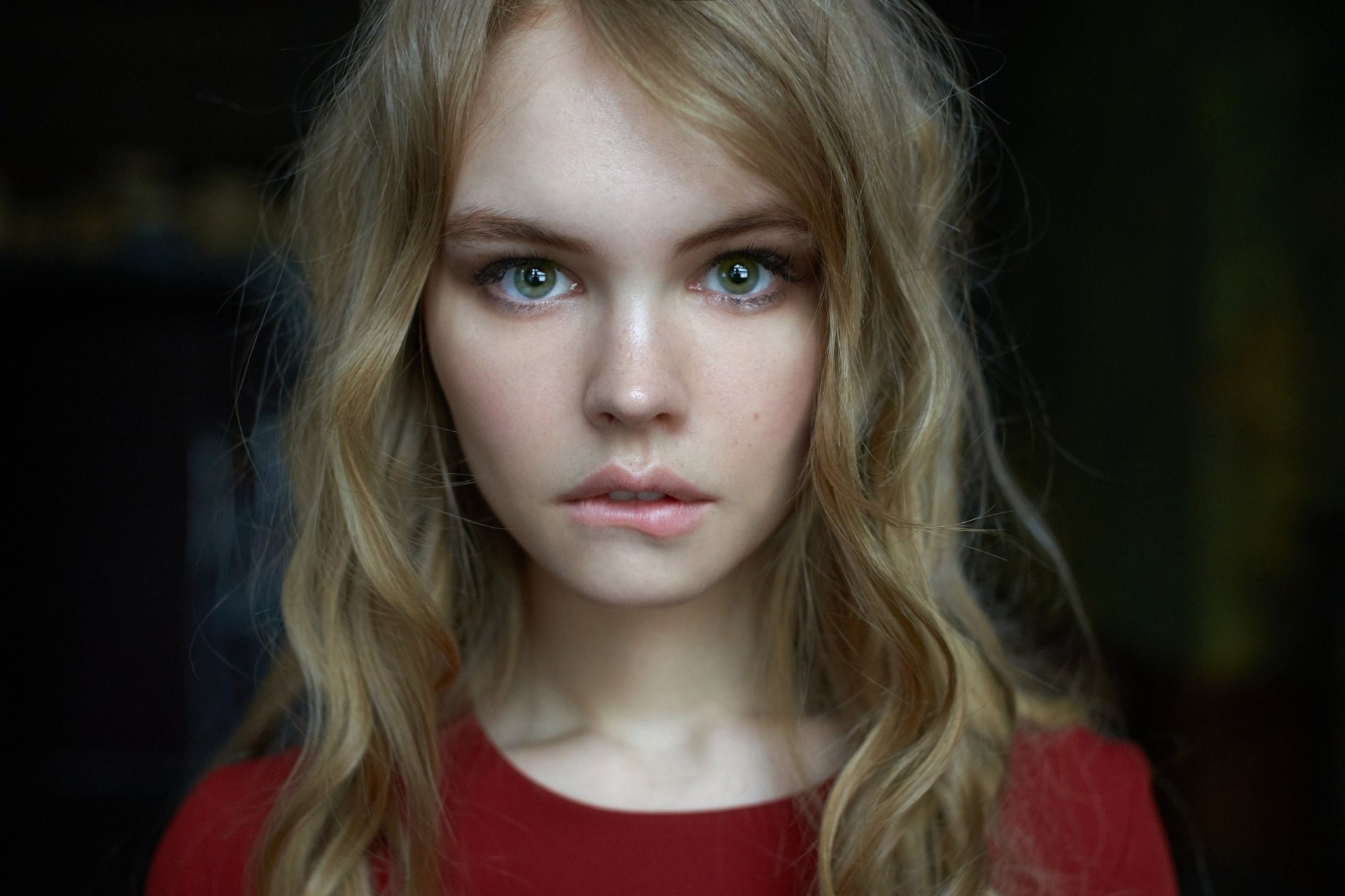 HD desktop wallpaper and background featuring a Russian model with green eyes and long blonde hair, identified as Anastasiya Scheglova. She is gazing directly at the camera with a serene expression.