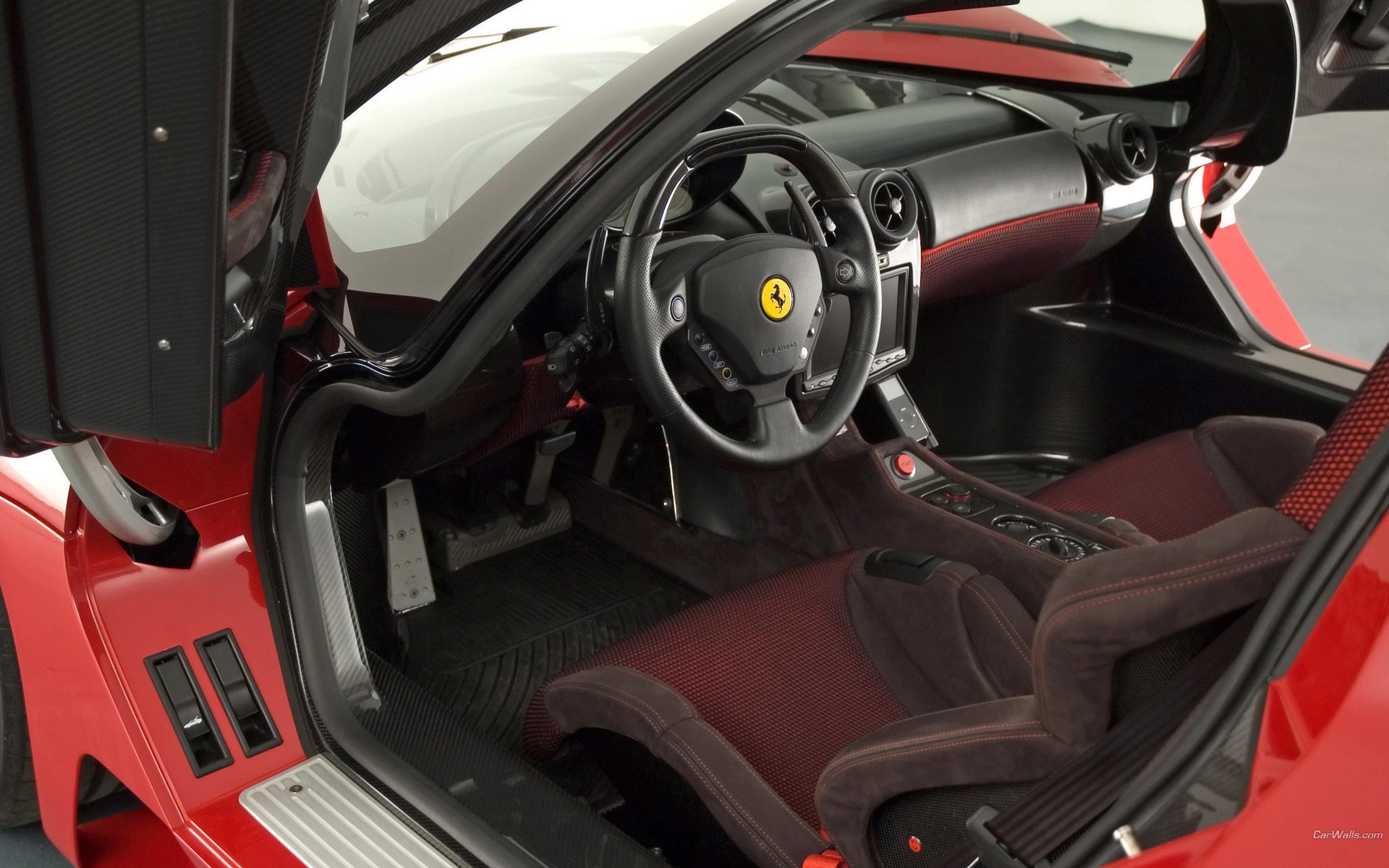 HD PC desktop wallpaper showing the red Ferrari Pininfarina P4/5 concept vehicle interior and cockpit, steering wheel with Ferrari badge.
