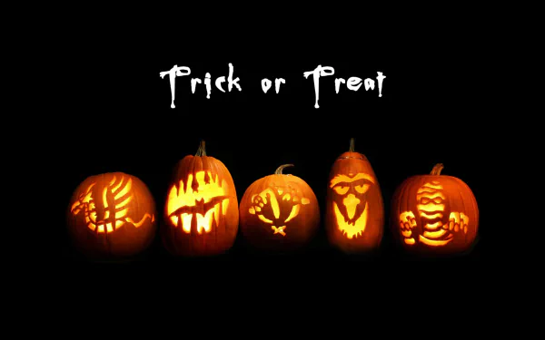 2K Quad HD PC desktop wallpaper: five glowing carved jack-o'-lanterns with varied spooky faces beneath the Trick or Treat text on a black Halloween background.