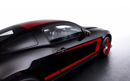 A sleek black Ford Mustang Boss 302 showcases its sporty design with a striking red accent. This high-definition image captures the essence of a classic muscle car.