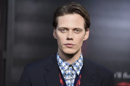 HD PC desktop wallpaper featuring Swedish actor and celebrity Bill Skarsgård in a patterned shirt and dark jacket against a blurred background.