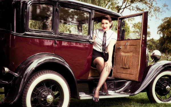 HD PC desktop wallpaper showing a woman in vintage attire sitting in the open door of a classic car, blending Girls & Cars themes with a nostalgic outdoor setting.