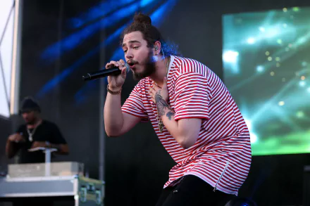 HD desktop wallpaper featuring a musician performing on stage with a microphone, against a backdrop with green lights.