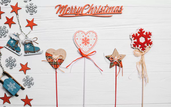 Festive Merry Christmas 4K Ultra HD wallpaper featuring holiday-themed ornaments including stars, snowflakes, hearts, and bells on a white wooden background.