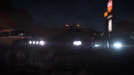 HD PC wallpaper featuring a Nissan Skyline GT-R V-Spec II from Need for Speed Payback, set in a dark, moody environment near a gas station.