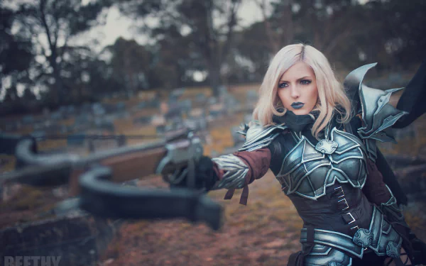 A woman cosplaying as a Demon Hunter from Diablo III stands poised with a crossbow in a detailed and intricate costume. The background is a high-definition forest scene set as a desktop wallpaper.
