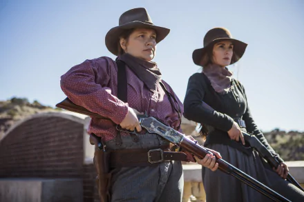 HD desktop wallpaper featuring two women in Western attire with guns, representing a scene tagged with Godless.