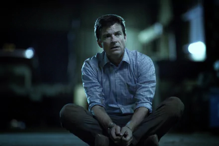 HD wallpaper featuring a character from Ozark, portrayed by Jason Bateman, sitting pensively in a dimly lit setting.