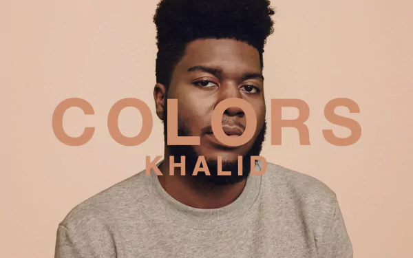 HD desktop wallpaper featuring a portrait with the text COLORS KHALID on a soft peach background.