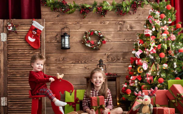 A little boy and girl smile joyfully by a decorated Christmas tree, surrounded by holiday gifts and festive decor, captured in 4K Ultra HD.