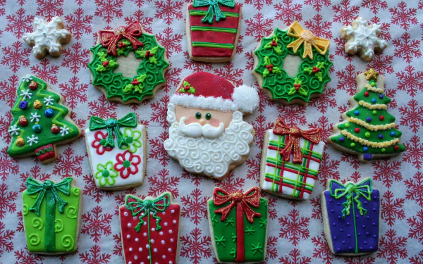 Colorful Christmas-themed cookies shaped like Santa, wreaths, trees, and gifts arranged on a festive red and white snowflake-patterned background, HD desktop wallpaper.