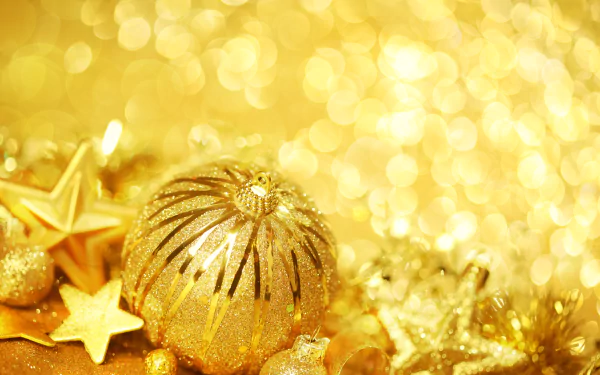 Golden Christmas baubles and star ornaments glow against a sparkling bokeh background in this festive 4K Ultra HD holiday desktop wallpaper.