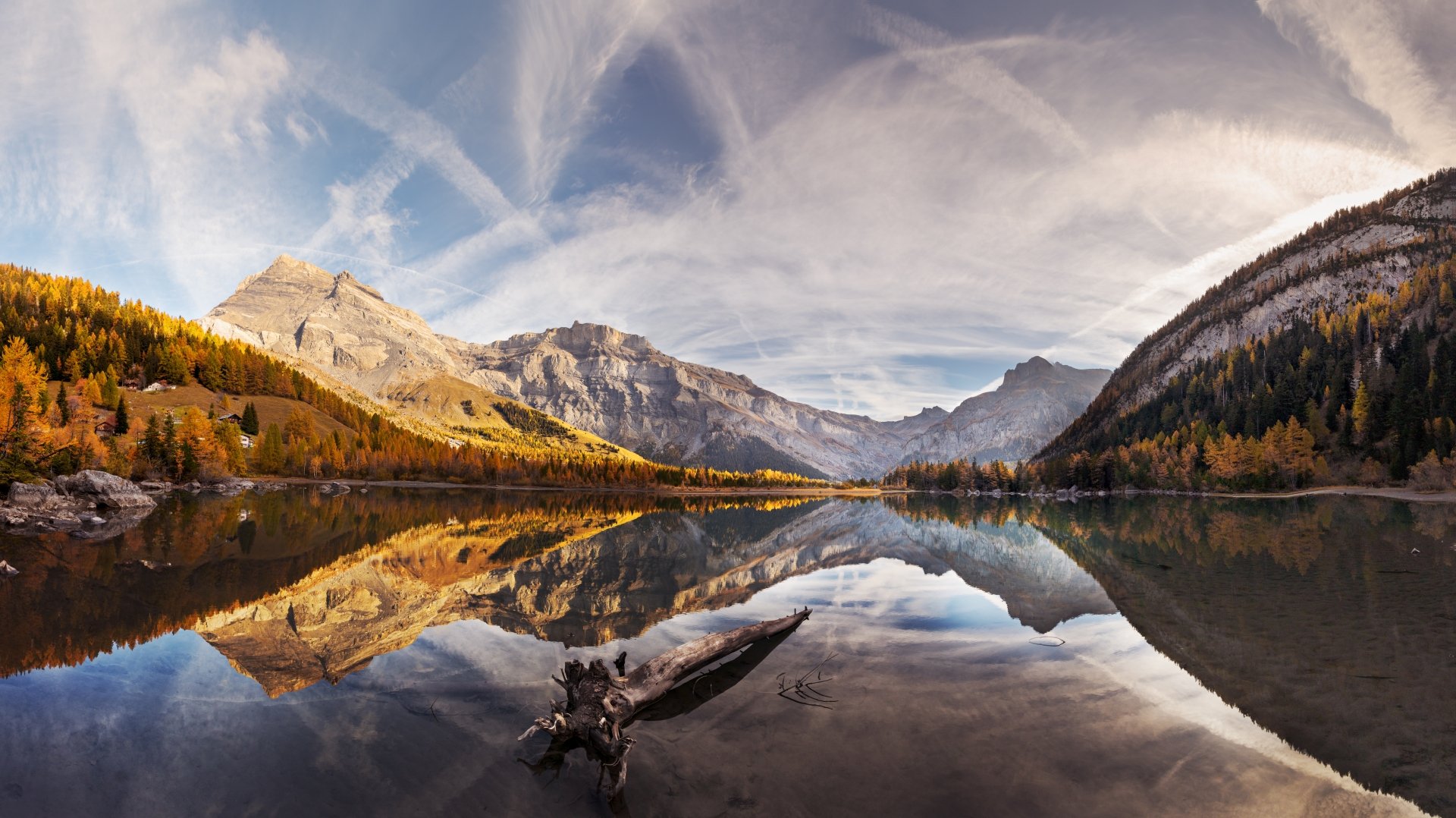 8K Ultra HD wallpaper showcasing a serene mountain landscape with autumn trees, a calm lake, and a clear reflection under a partly cloudy sky.