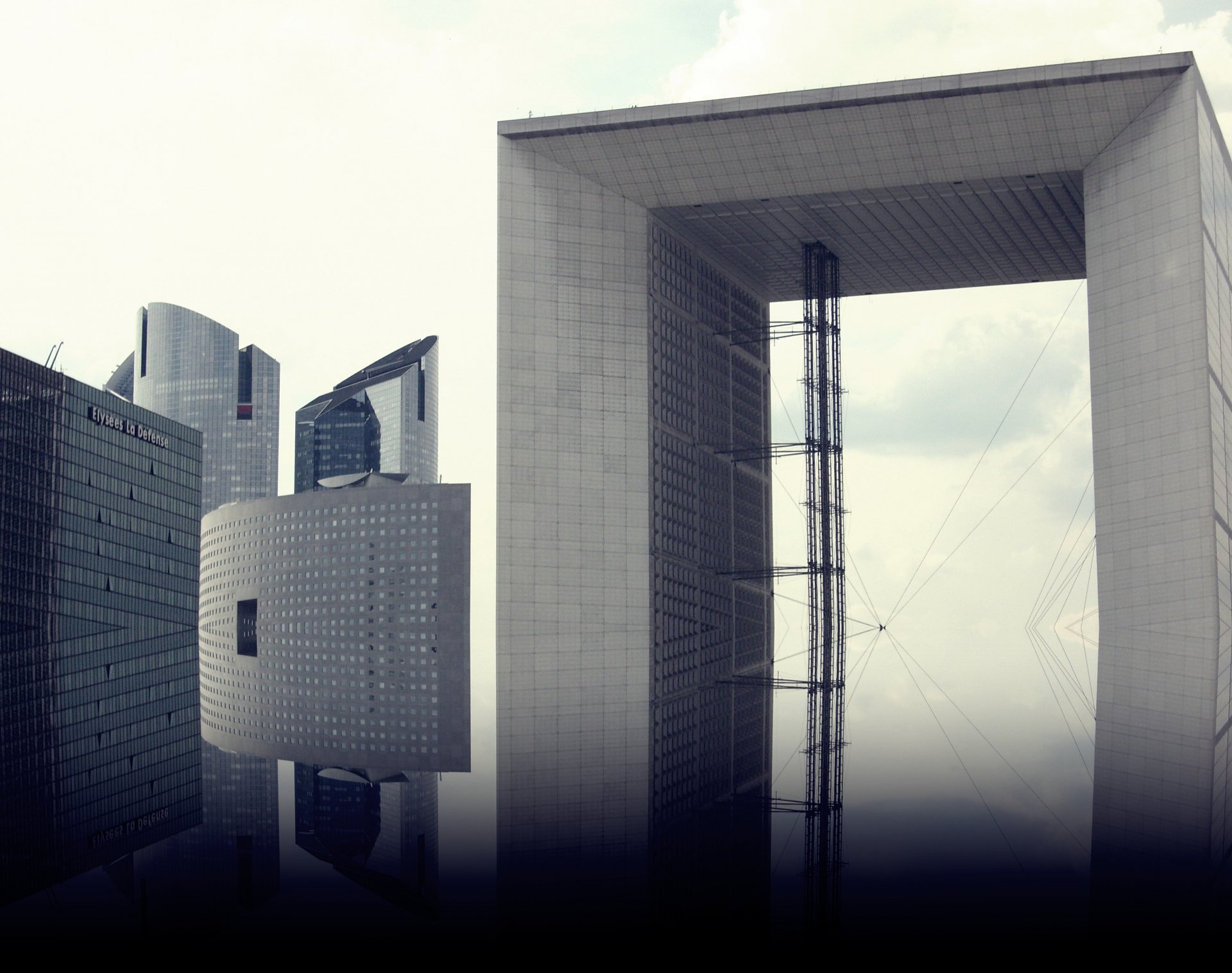 HD PC desktop wallpaper showcasing a man-made architectural scene with modern buildings, including a large rectangular frame structure and cylindrical towers.