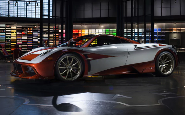 Sleek Pagani Huayra supercar showcased indoors with dynamic lighting, presented as a 4K Ultra HD PC desktop wallpaper and background.