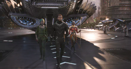 Three characters from the movie Black Panther walk in front of a futuristic aircraft. The image is a high-definition desktop wallpaper background.