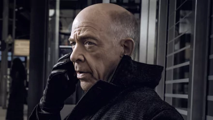 HD desktop wallpaper featuring a character from the series Counterpart, portrayed by an actor on the phone with a serious expression.
