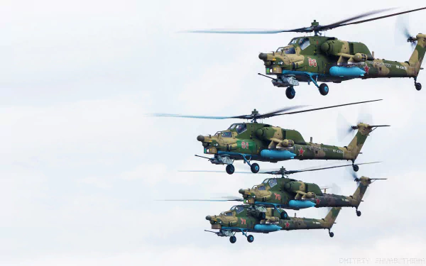 Three Mil Mi-28 attack helicopters fly in formation against a clear sky in this HD military aircraft wallpaper.