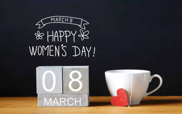 4K Ultra HD desktop wallpaper featuring a white cup with a red heart tag, wooden calendar blocks showing March 8, and Happy Women's Day text on a black background.