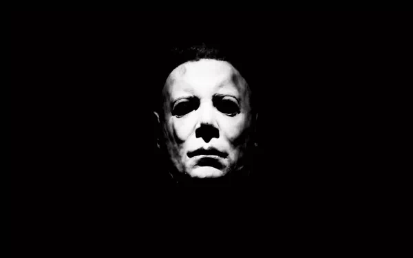 A striking black and white HD wallpaper featuring Michael Myers from the classic Halloween (1978) movie, capturing his iconic expression against a dark background.