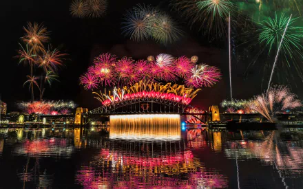 HD desktop wallpaper of colorful fireworks illuminating the night sky over the Sydney Harbour Bridge, capturing the vibrant cityscape reflected in the water.