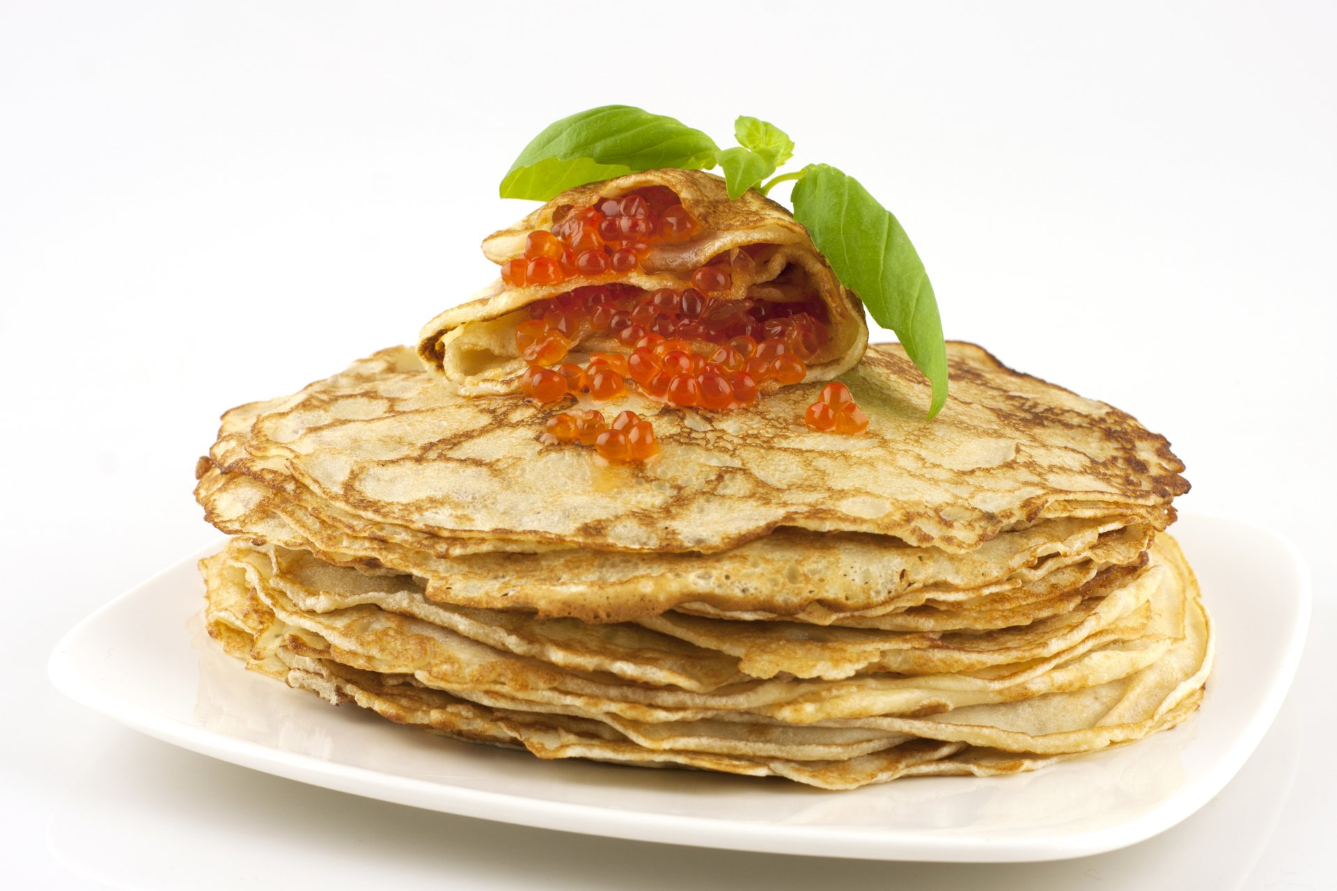 Golden crêpes stacked on a white plate, topped with red caviar and basil — food, 4K Ultra HD PC desktop wallpaper and background.