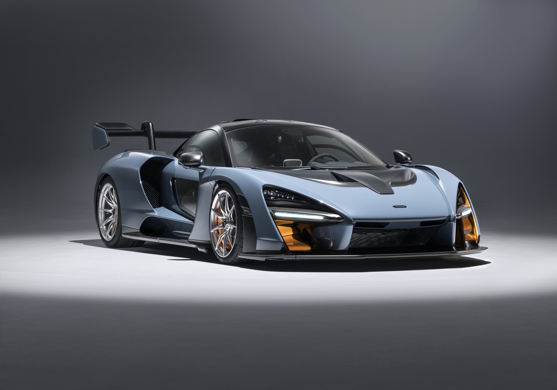 A sleek McLaren Senna supercar showcased in a high-resolution 4K Ultra HD wallpaper, highlighting its aerodynamic design and striking details.
