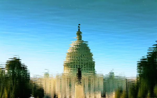 Reflection of the United States Capitol Building on rippling water, captured in sharp 4K Ultra HD detail.