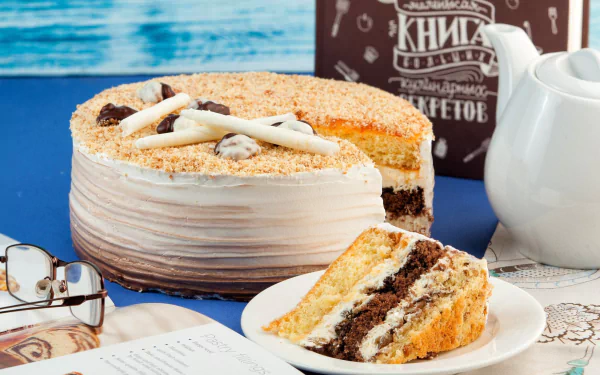 HD desktop wallpaper featuring a still life of a layered cake, a white kettle, and a slice of pastry on a plate, set against a blue background.