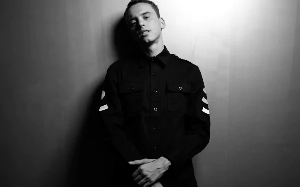 HD desktop wallpaper of a person in a black shirt posed against a grey background, related to the theme of Logic.
