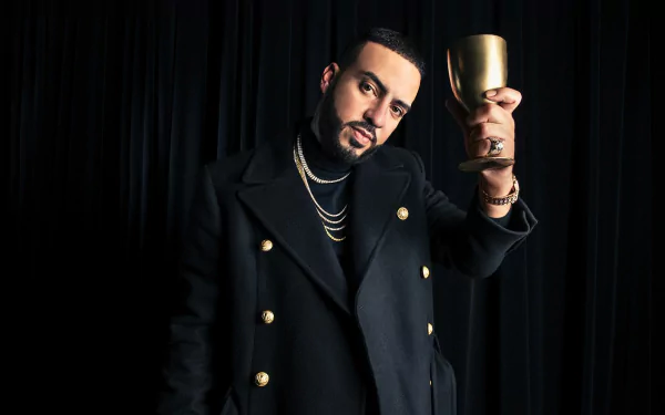 HD desktop wallpaper featuring a person in a stylish black jacket holding a gold cup, against a dark background.