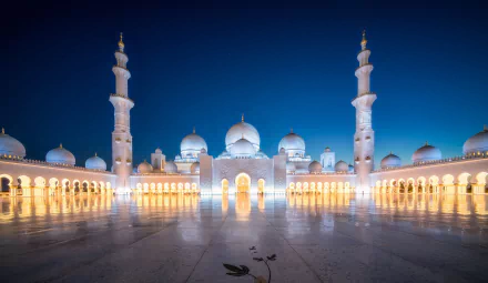 Sheikh Zayed Grand Mosque in Abu Dhabi, United Arab Emirates, illuminated at night showcasing its stunning architecture and religious significance.
