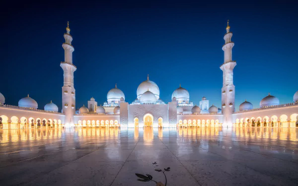Sheikh Zayed Grand Mosque in Abu Dhabi, United Arab Emirates, illuminated at night showcasing its stunning architecture and religious significance.