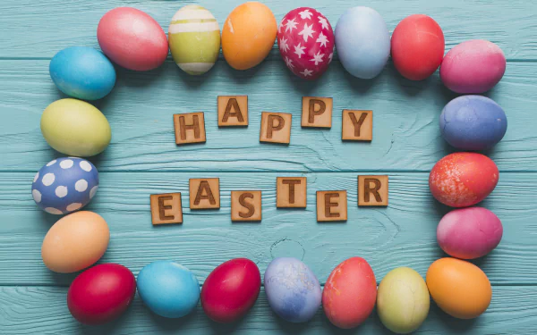 A colorful array of Easter eggs arranged in an oval around wooden tiles spelling Happy Easter on a blue wooden background, captured in 4K Ultra HD.