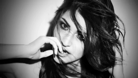 Monochrome 4K Ultra HD portrait of Indian actress Anushka Sharma with expressive eyes and tousled hair, captured in a striking black and white close-up.