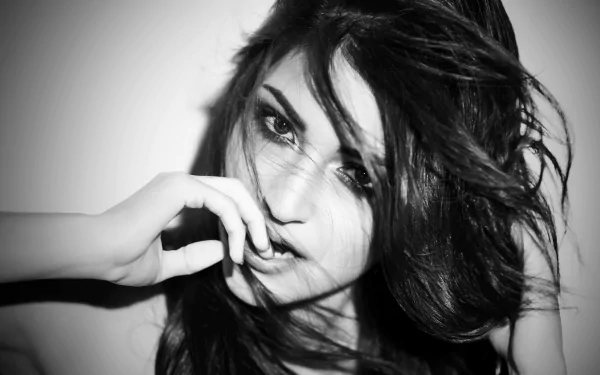 Monochrome 4K Ultra HD portrait of Indian actress Anushka Sharma with expressive eyes and tousled hair, captured in a striking black and white close-up.