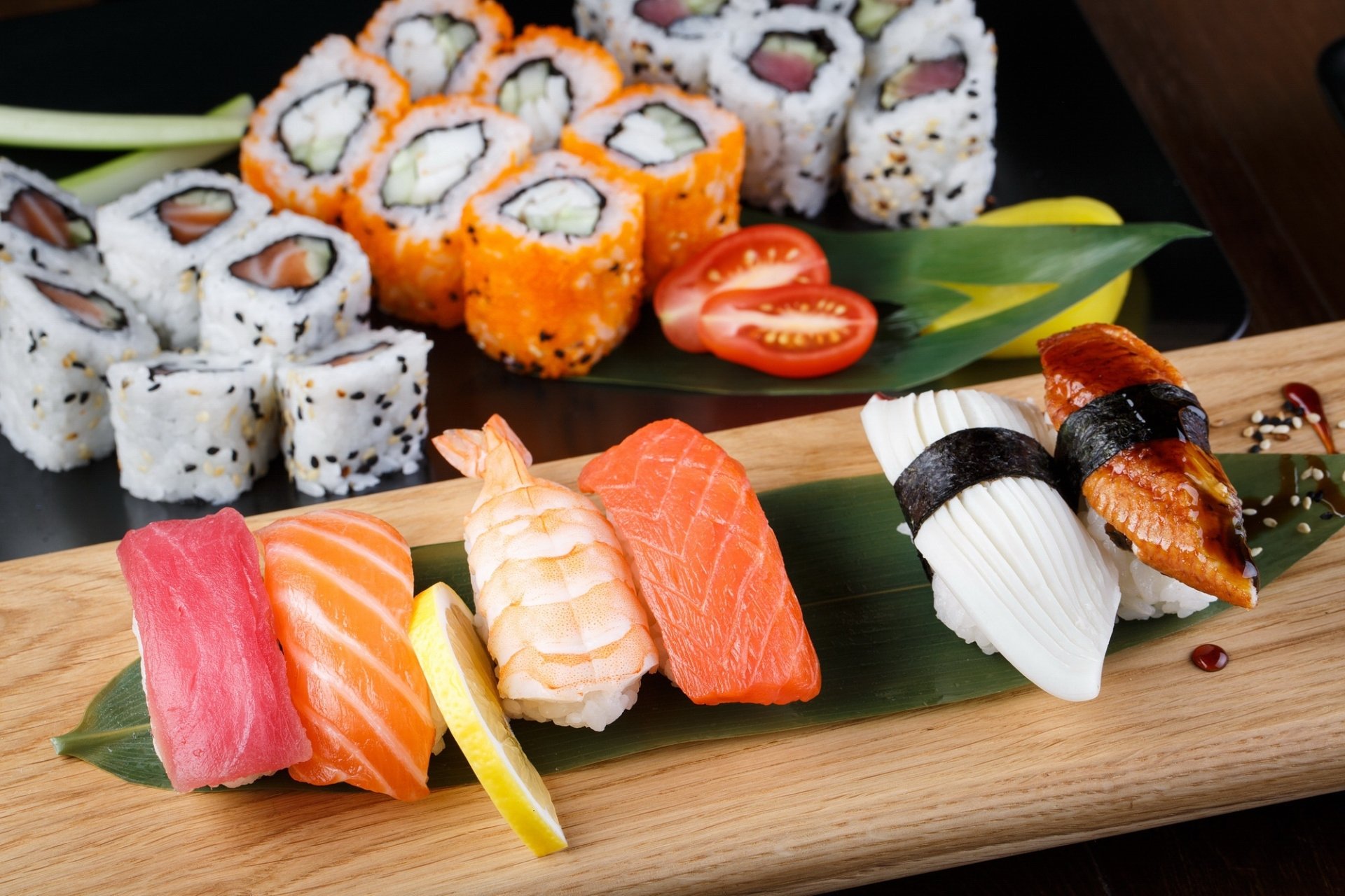 HD PC desktop wallpaper of a vibrant still life featuring assorted sushi, rice, fish, and seafood artfully arranged with fresh garnish on a wooden board.