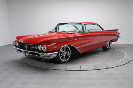 HD desktop wallpaper showcasing a classic red Buick LeSabre vehicle in a showroom setting with polished chrome details and sleek vintage design.
