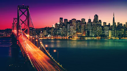 A vibrant 4K Ultra HD image of California’s San Francisco cityscape at sunset, featuring the illuminated Bay Bridge glowing under warm sunlight.