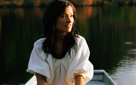 A serene portrait of Olivia Wilde, captured in natural light, with a tranquil lake backdrop, making this an elegant HD desktop wallpaper.
