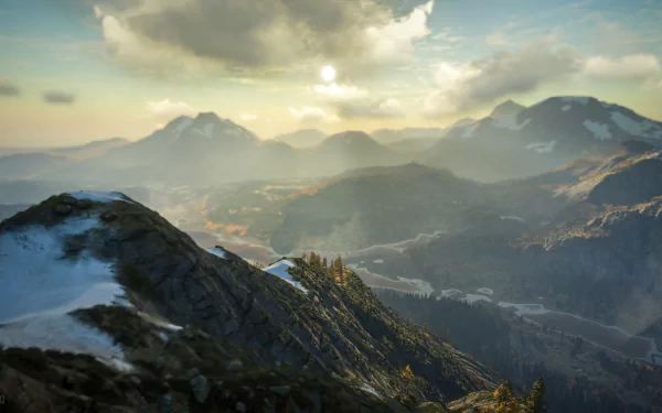 4K Ultra HD desktop wallpaper from theHunter: Call of The Wild featuring a misty mountain landscape bathed in soft sunlight and natural wilderness.