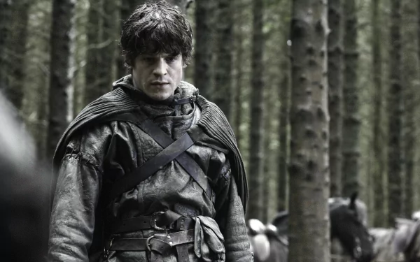 Ramsay Bolton (Game of Thrones) stares grimly in a dim pine forest, cloaked and battle-worn — 4K Ultra HD PC desktop wallpaper/background.
