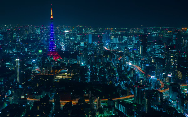 A vibrant night view of Tokyo’s cityscape featuring skyscrapers and the illuminated Tokyo Tower, captured in stunning 4K Ultra HD quality.