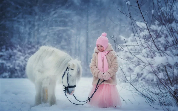 Cute little girl in a pink hat and tutu leading a white pony through a snowy winter forest — HD PC desktop wallpaper background.