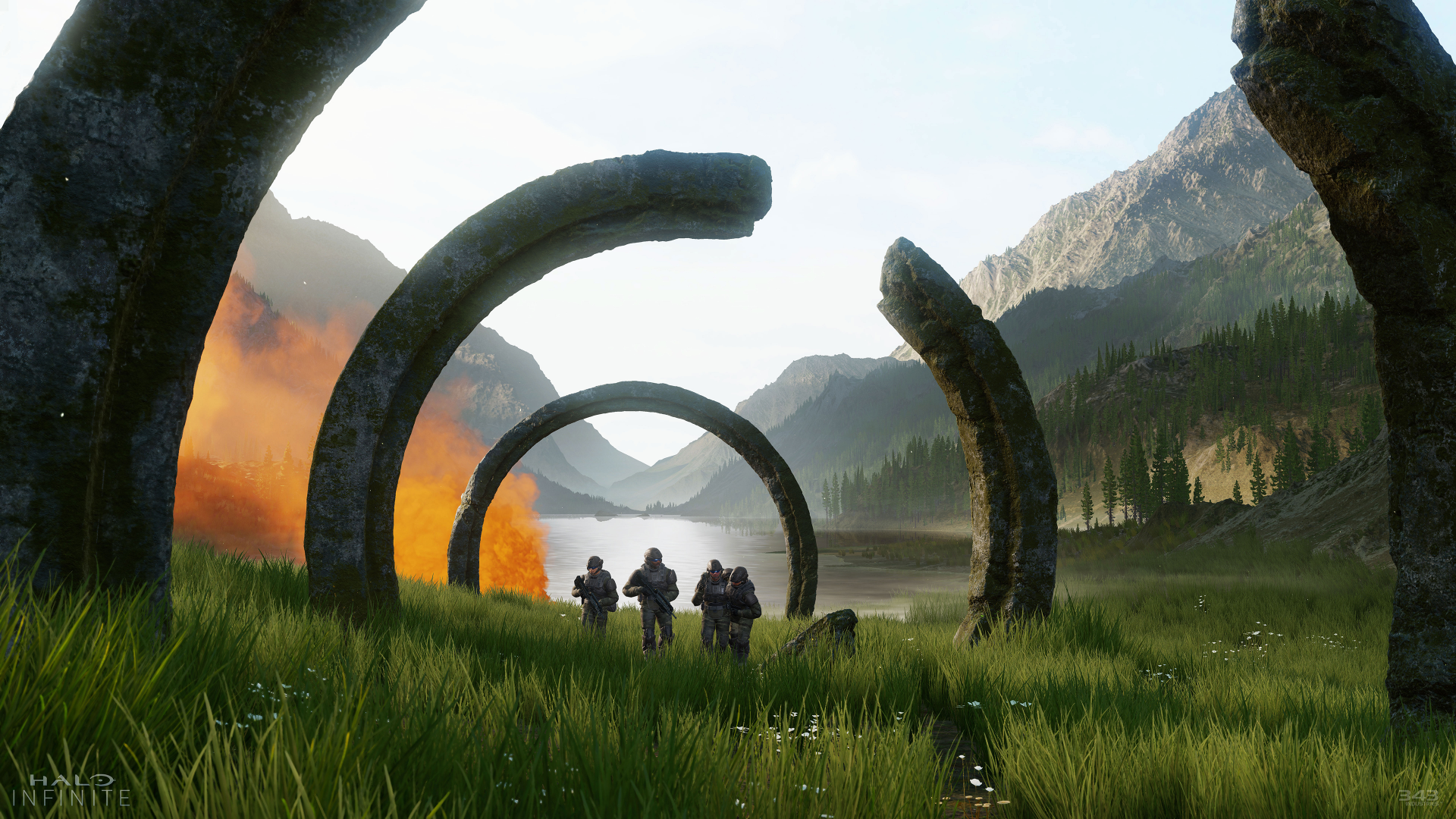 HD desktop wallpaper from Halo Infinite featuring soldiers in a scenic landscape with iconic ring structures and mountains in the background.
