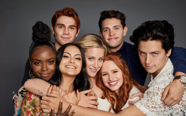 HD desktop wallpaper featuring the cast of the TV show 'Riverdale,' with the characters embracing and smiling against a plain backdrop.